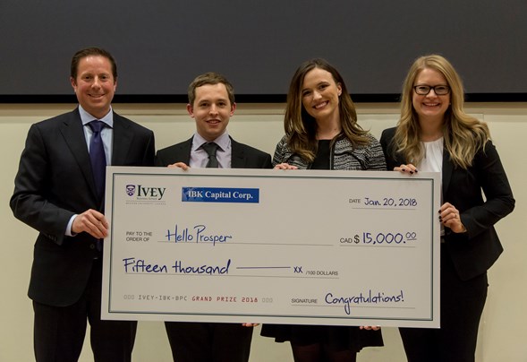 holding large cheque winner MBA Ivey Business Plan Competition