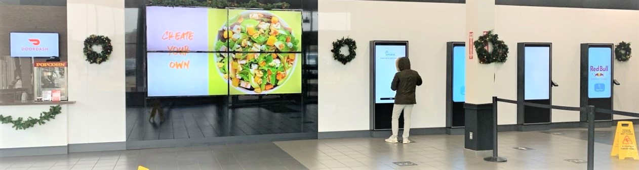 A man standing at a digital screen