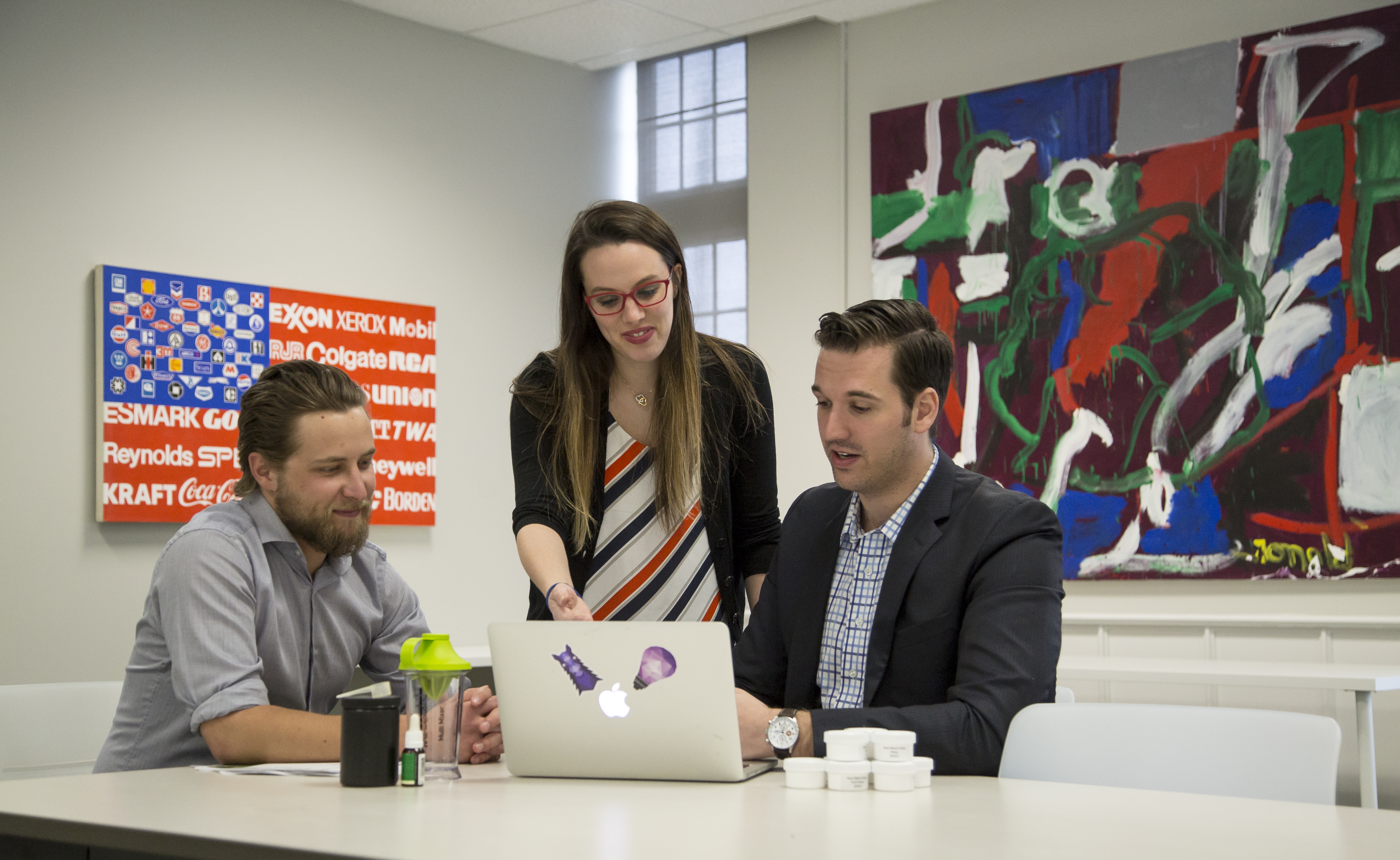 Female Entrepreneurship Coach Helping Two Male Entrepreneurs On Laptop (1)