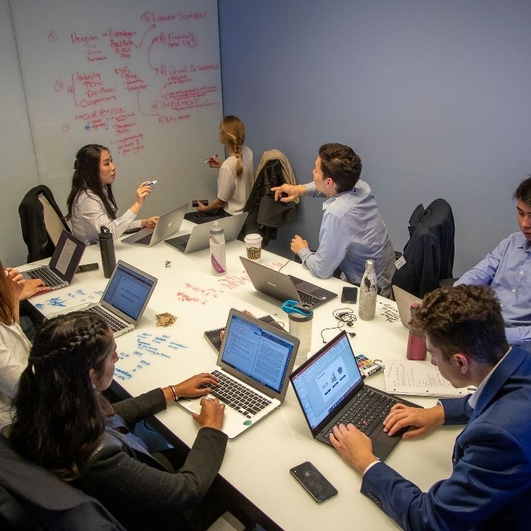 Students Working Around A White Board Table And Brainstorning On Whiteboard