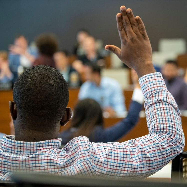 Student Raising His Hand In Class